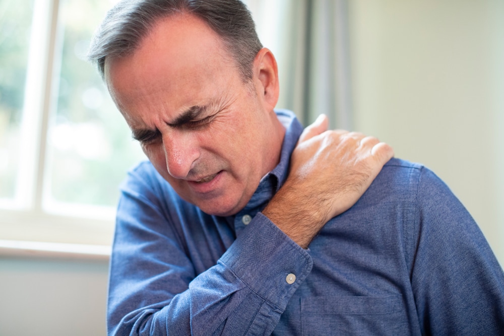 Man holding shoulder in pain